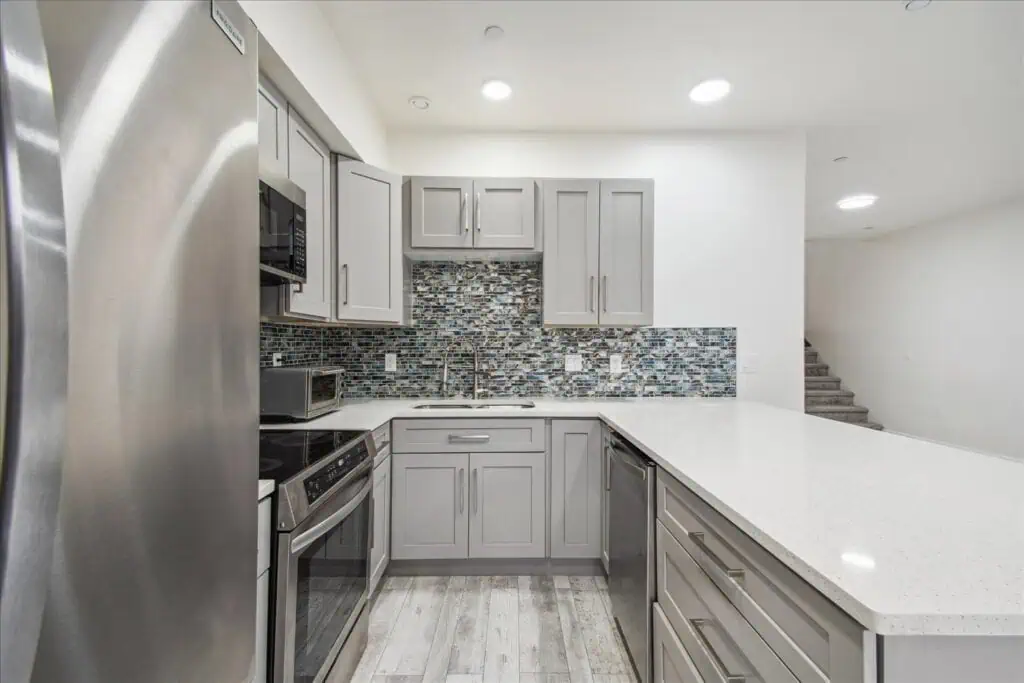 Modern kitchen with gray cabinets and island.