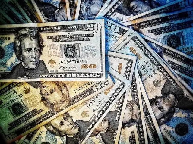 Pile of US dollar bills in various denominations.