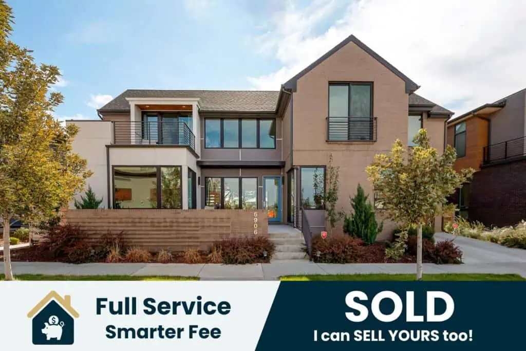 Modern house with sold sign and trees.