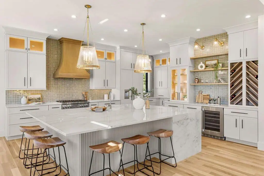 Modern kitchen with island and wooden stools.