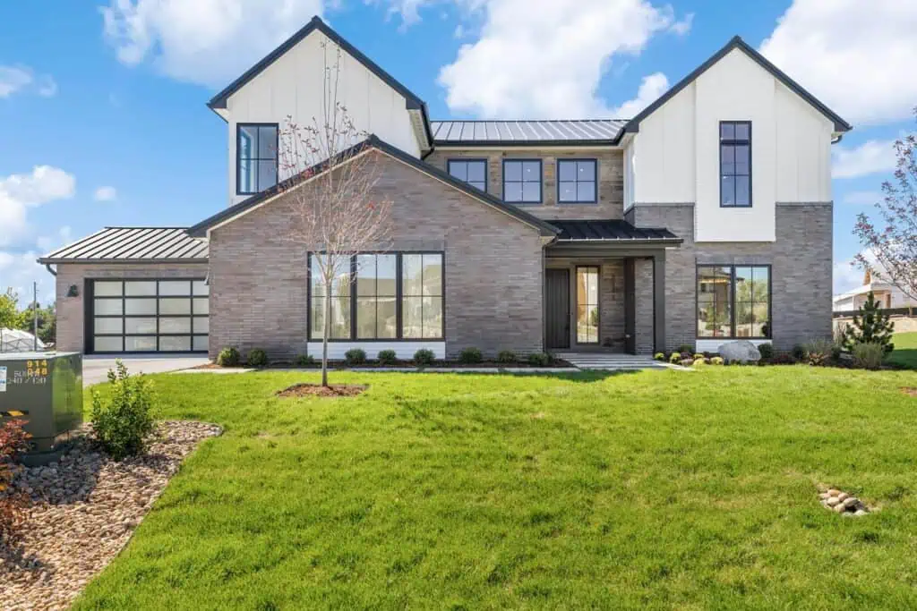 Modern suburban house with green lawn.