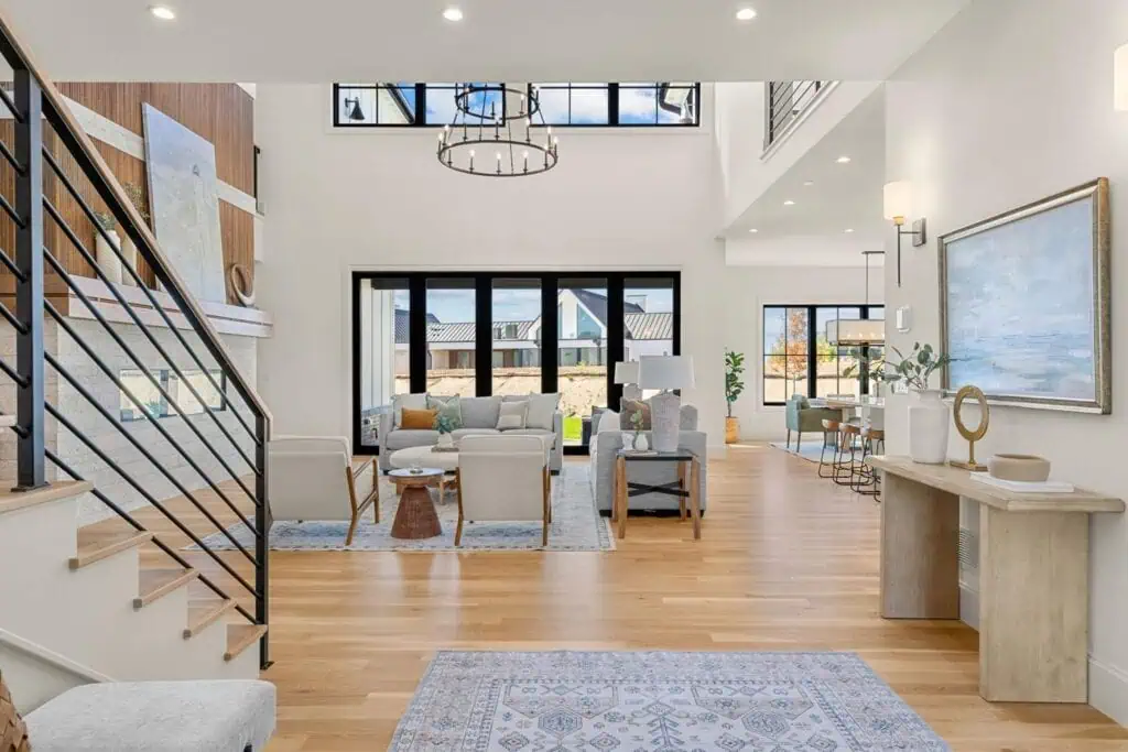 Modern living room with large windows and decor.
