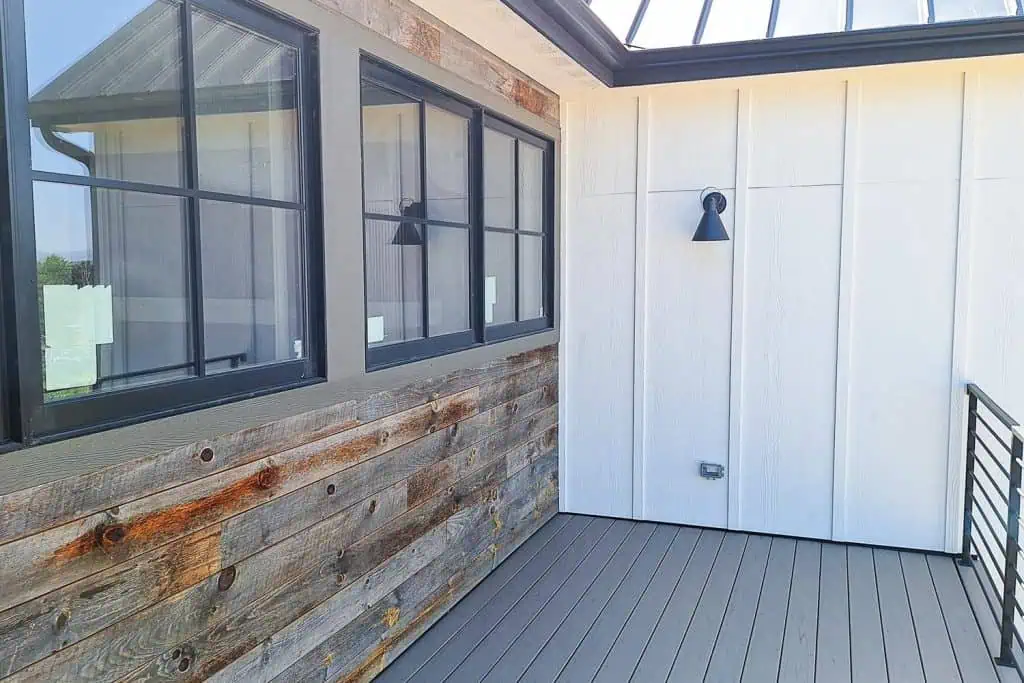 Modern patio with metal rail and wooden wall