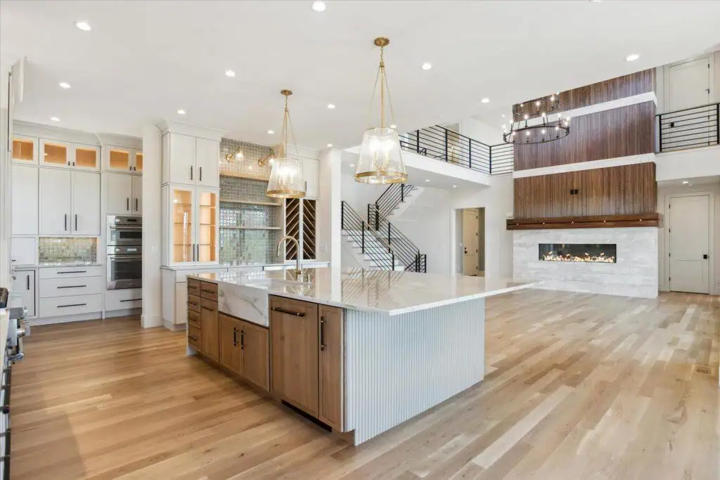 Modern kitchen with island and pendant lights.