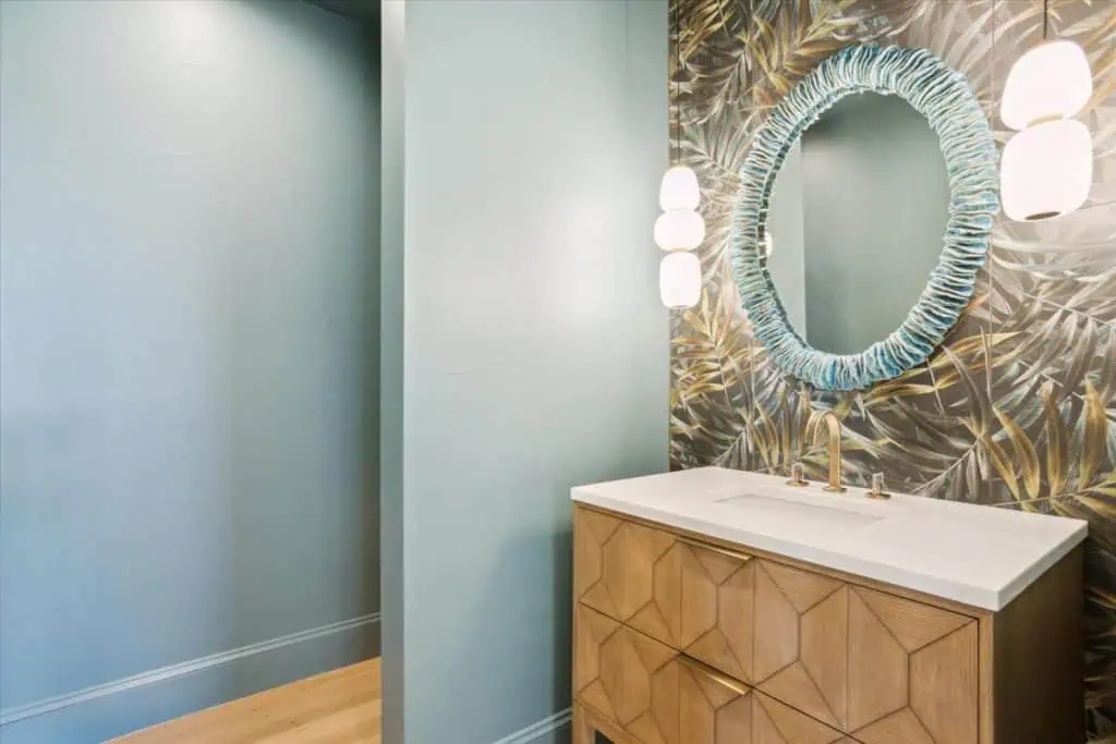 Stylish bathroom with decorative wallpaper and mirror
