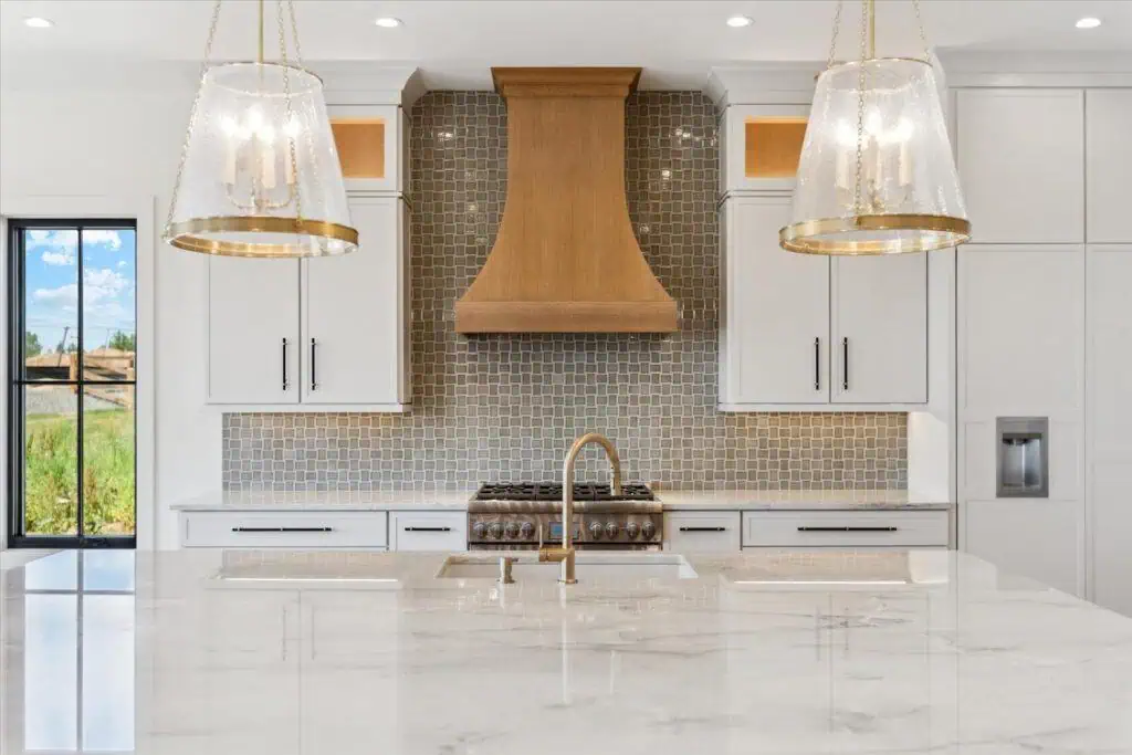 Modern kitchen with marble island and wooden hood