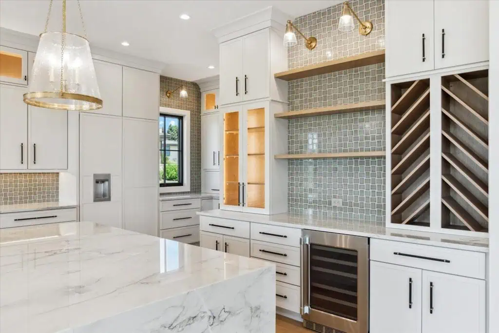 Modern kitchen with wine rack and marble countertop.