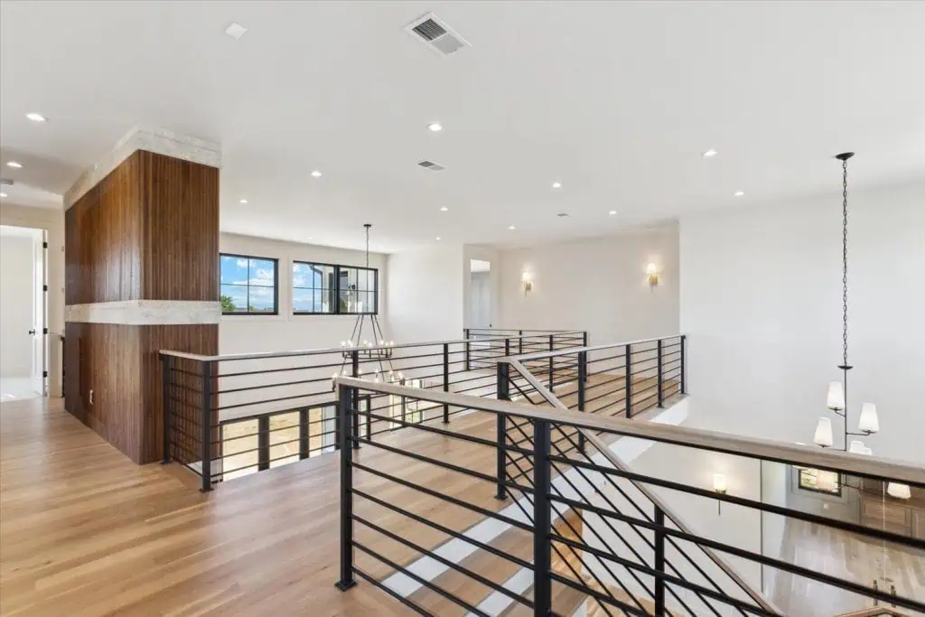 Modern open staircase with wooden floors and railing.