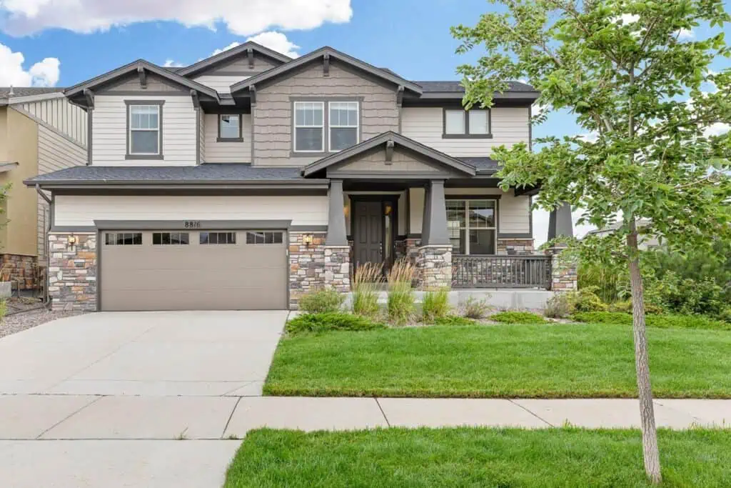 Two-story suburban house with garage and front yard.