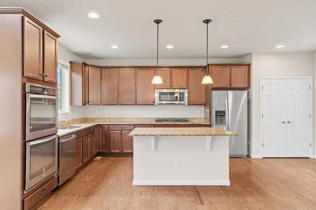 Spacious kitchen with wooden cabinets and island.