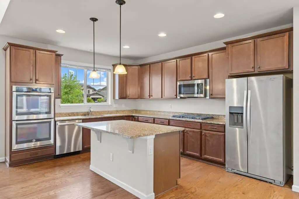 Modern kitchen with island and stainless steel appliances.