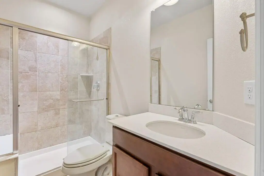 Modern bathroom with glass shower and vanity.