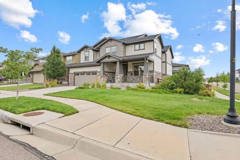Modern suburban house with manicured lawn and driveway.