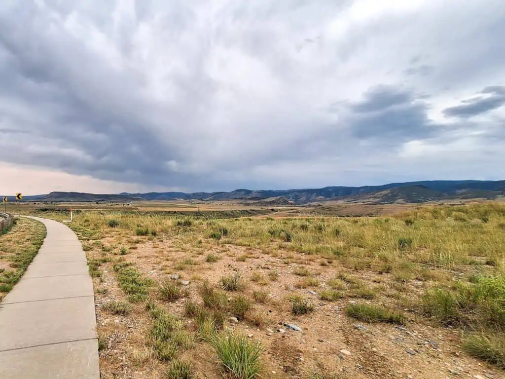 Mountain landscape with cloudy sky and path.