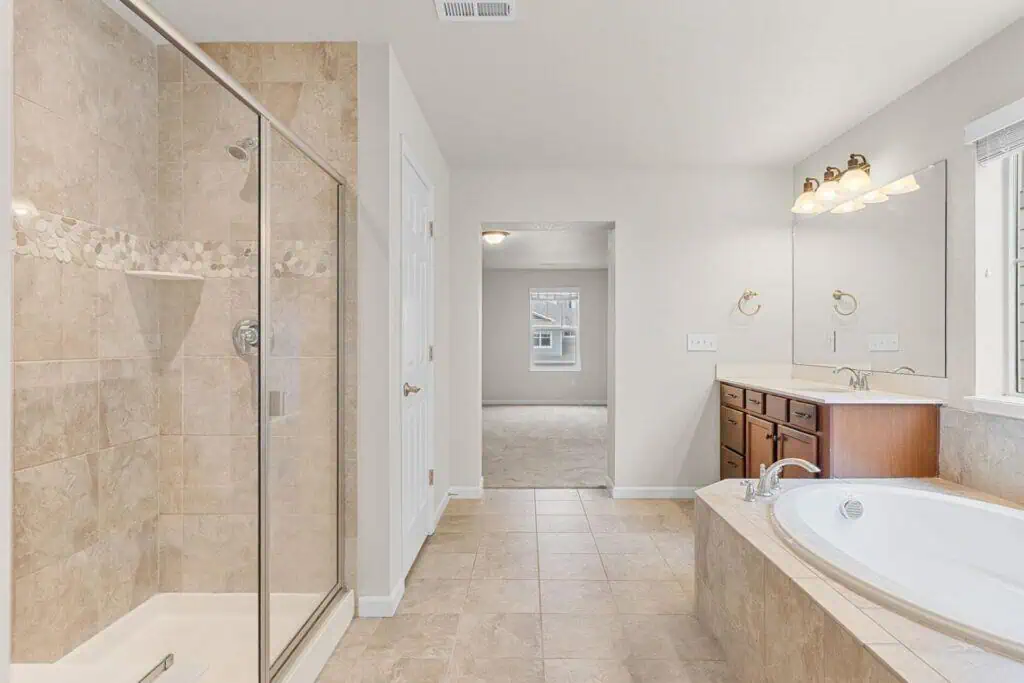 Spacious bathroom with bathtub and shower