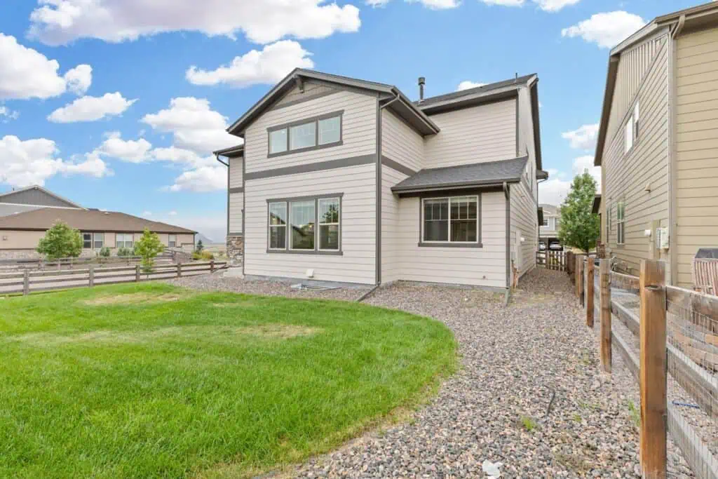 Modern two-story house with spacious backyard.
